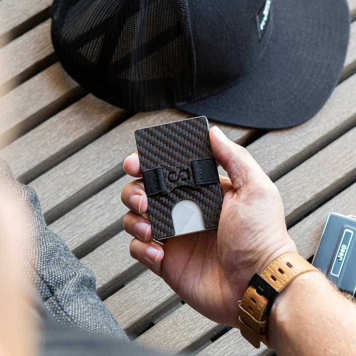 a person holding a cell phone in their hands