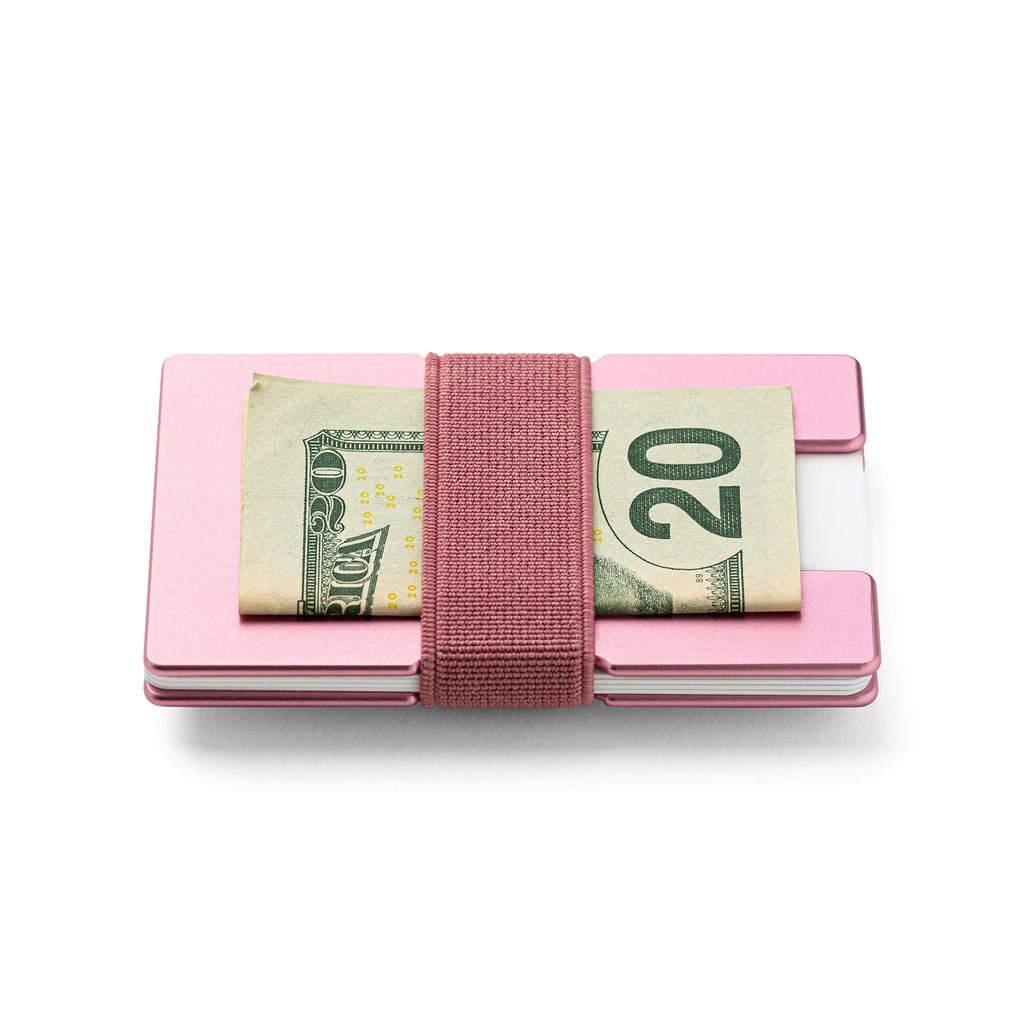 a pink piece of luggage sitting on top of a table 