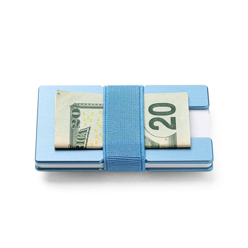 a blue and white cell phone sitting on a table 